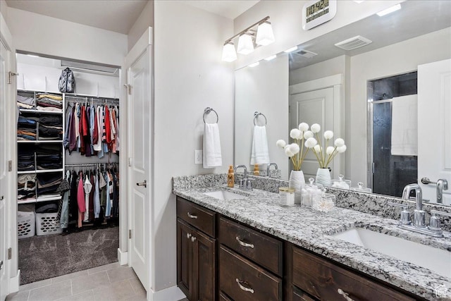 1949 N 2350 W Unit 203, Clinton, UT 84015 - full bath with double vanity, a shower stall, tile patterned floors, and a walk in closet