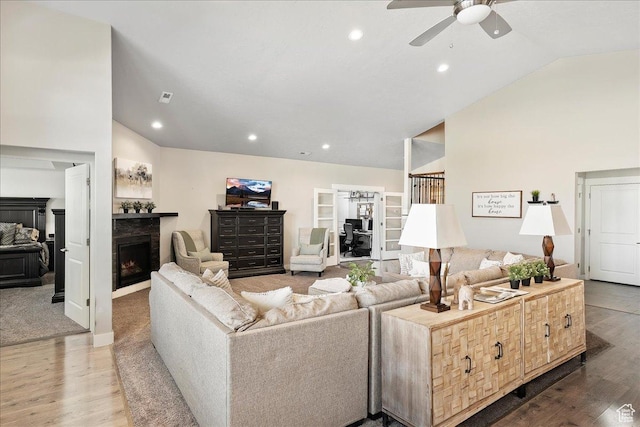 1949 N 2350 W Unit 203, Clinton, UT 84015 - living area with vaulted ceiling, a lit fireplace, wood finished floors, a ceiling fan, and recessed lighting