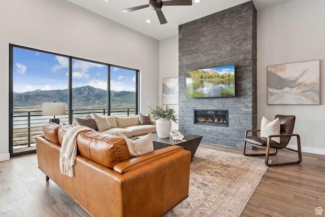 11811 N Apex Way Unit 66, Hideout, UT 84036 - living area with ceiling fan, a fireplace, wood finished floors, recessed lighting, and a high ceiling