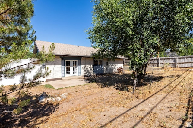 10257 S 1280 E, Sandy, UT 84094 - back of property featuring french doors, a patio area, and roof with shingles