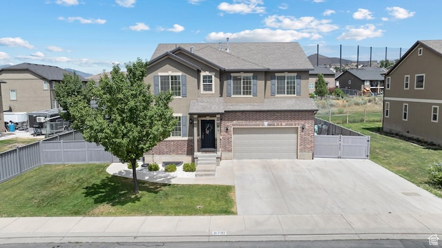 8791 N Suffolk Ln, Eagle Mountain, UT 84005 - traditional home featuring an attached garage, brick siding, concrete driveway, roof with shingles, and a gate