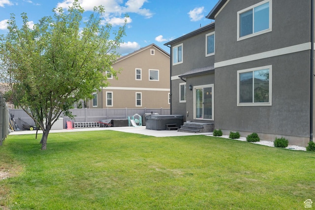 8791 N Suffolk Ln, Eagle Mountain, UT 84005 - back of property with a hot tub, a patio area, and stucco siding