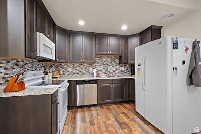 8791 N Suffolk Ln, Eagle Mountain, UT 84005 - kitchen with white appliances, dark brown cabinetry, wood finished floors, decorative backsplash, and light stone countertops