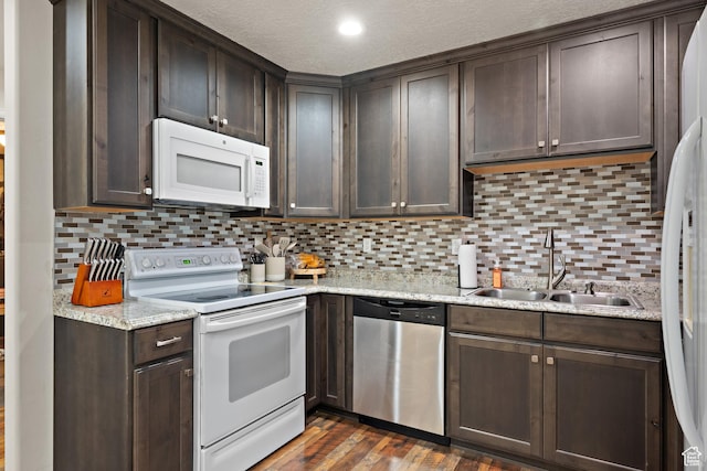 8791 N Suffolk Ln, Eagle Mountain, UT 84005 - kitchen featuring white appliances, dark brown cabinetry, dark wood-style flooring, tasteful backsplash, and a textured ceiling