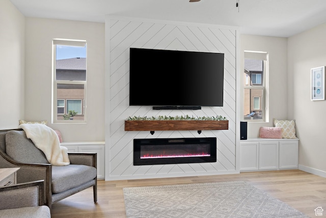 8791 N Suffolk Ln, Eagle Mountain, UT 84005 - living room featuring a large fireplace, light wood-style floors, and healthy amount of natural light