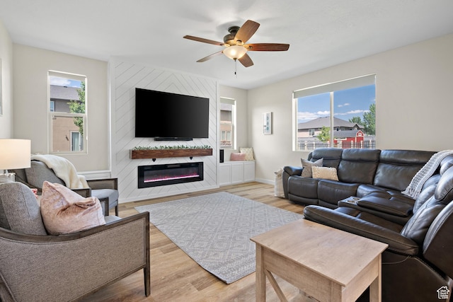 8791 N Suffolk Ln, Eagle Mountain, UT 84005 - living area featuring light wood-style flooring, ceiling fan, and a large fireplace
