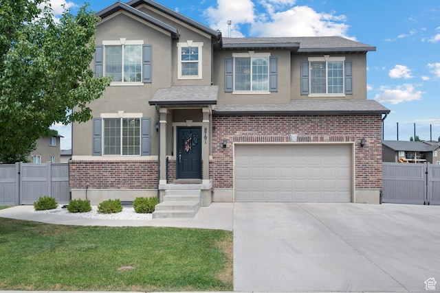 8791 N Suffolk Ln, Eagle Mountain, UT 84005 - view of front facade with stucco siding, an attached garage, concrete driveway, and brick siding