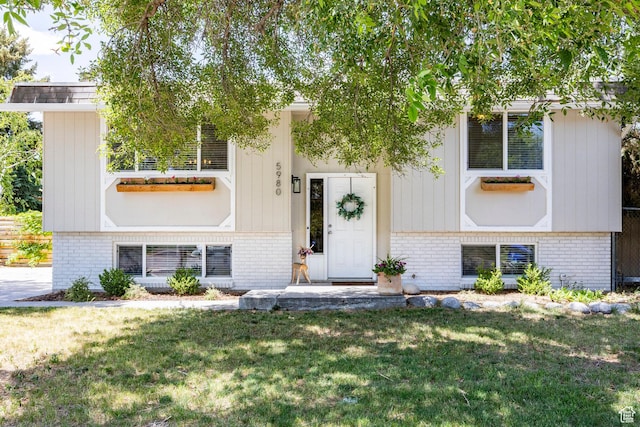 5980 S Sweet Basil W, Taylorsville, UT 84129 - view of front of house featuring brick siding and a front yard