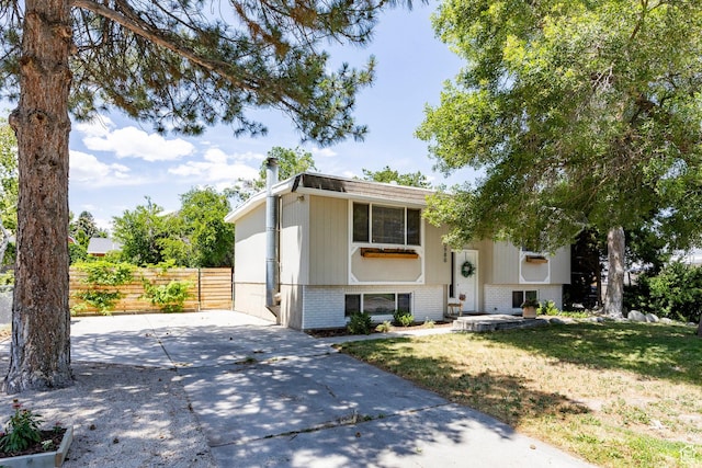 5980 S Sweet Basil W, Taylorsville, UT 84129 - split foyer home with brick siding, driveway, and a chimney