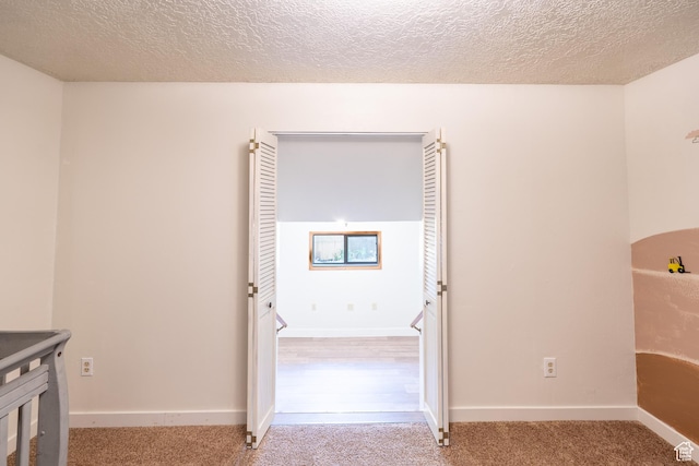 481 W Oak Crest Dr, Monticello, UT 84535 - hallway featuring a textured ceiling and carpet