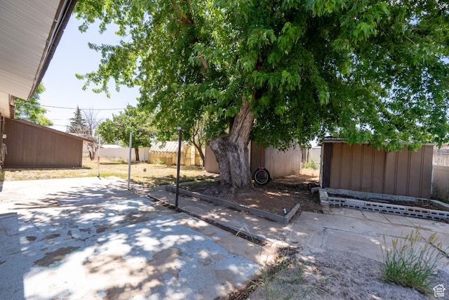 481 W Oak Crest Dr, Monticello, UT 84535 - fenced backyard featuring a storage unit and a patio area