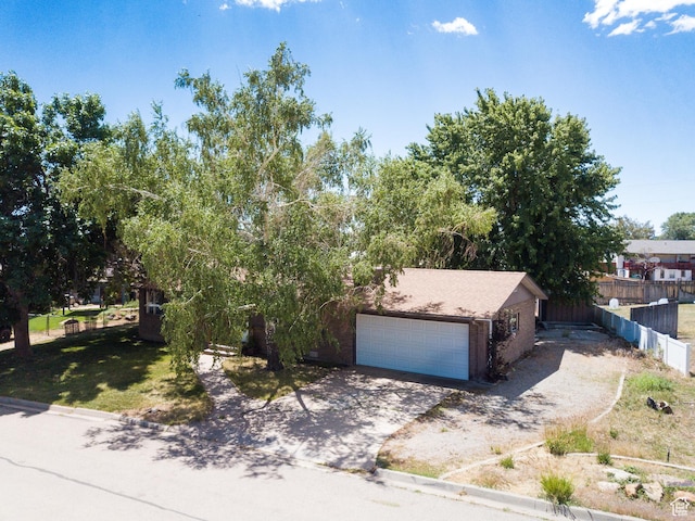 481 W Oak Crest Dr, Monticello, UT 84535 - view of property hidden behind natural elements with concrete driveway and an attached garage