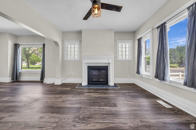 554 17th St, Ogden, UT 84404 - unfurnished living room featuring a ceiling fan, healthy amount of natural light, a fireplace, and dark wood finished floors