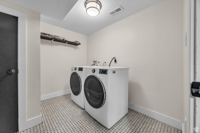 554 17th St, Ogden, UT 84404 - laundry room with washing machine and dryer, light flooring, and a textured ceiling