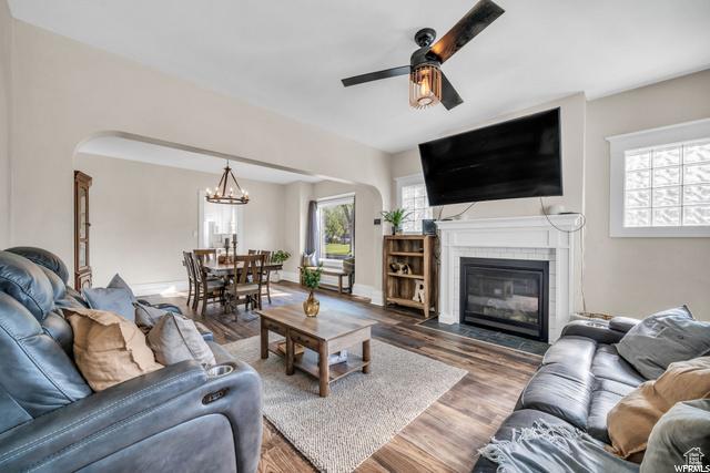 554 17th St, Ogden, UT 84404 - living area with ceiling fan, arched walkways, a chandelier, and wood finished floors