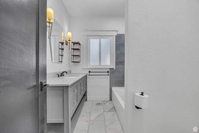 554 17th St, Ogden, UT 84404 - full bath with marble look tile flooring, vanity, and a tub to relax in