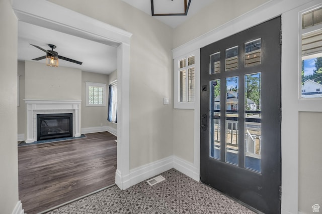 554 17th St, Ogden, UT 84404 - foyer entrance featuring ceiling fan, a fireplace with flush hearth, and wood finished floors