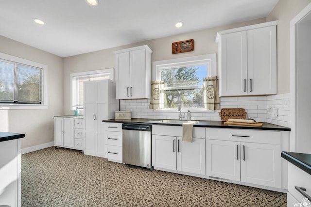 554 17th St, Ogden, UT 84404 - kitchen featuring dishwasher, dark countertops, healthy amount of natural light, white cabinetry, and recessed lighting