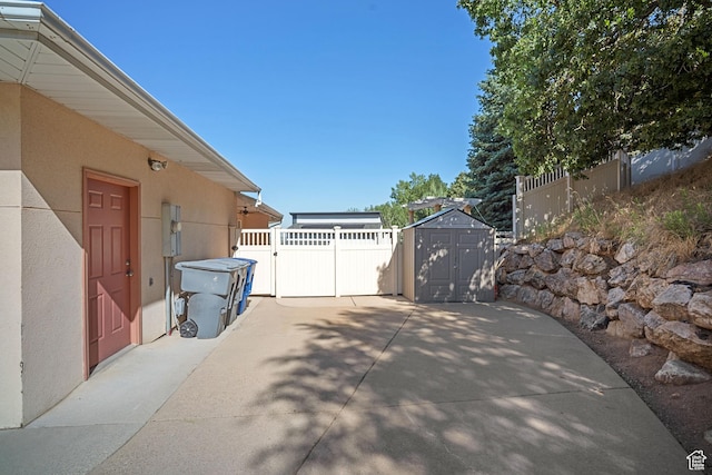 967 E Eaglewood Dr, North Salt Lake, UT 84054 - view of patio / terrace with a storage shed and a gate