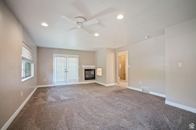 967 E Eaglewood Dr, North Salt Lake, UT 84054 - unfurnished living room featuring carpet floors, a ceiling fan, recessed lighting, and a glass covered fireplace