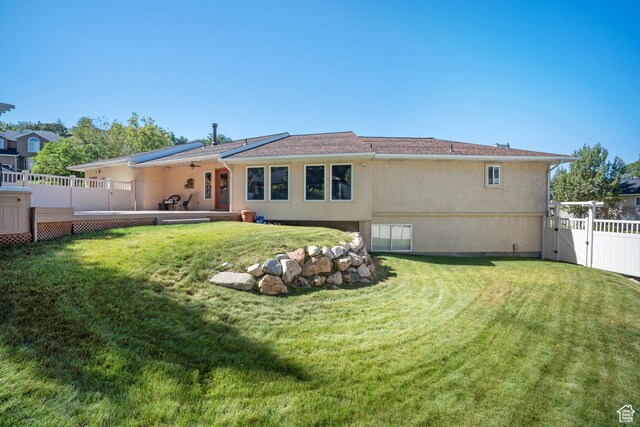 967 E Eaglewood Dr, North Salt Lake, UT 84054 - rear view of house with a gate, stucco siding, and a deck