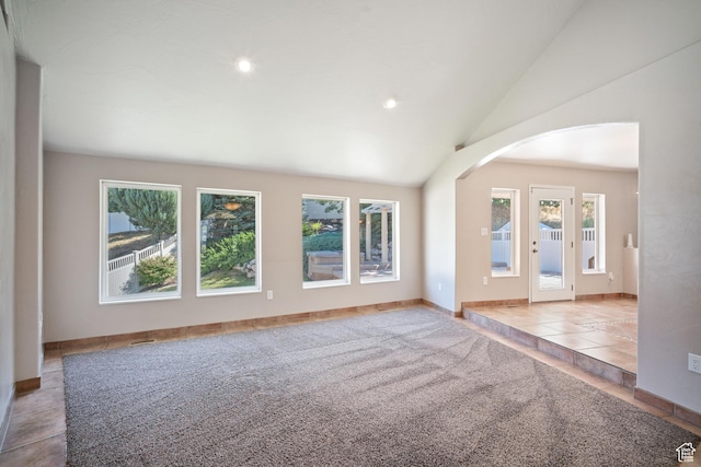 967 E Eaglewood Dr, North Salt Lake, UT 84054 - unfurnished room with arched walkways, vaulted ceiling, recessed lighting, tile patterned floors, and carpet floors