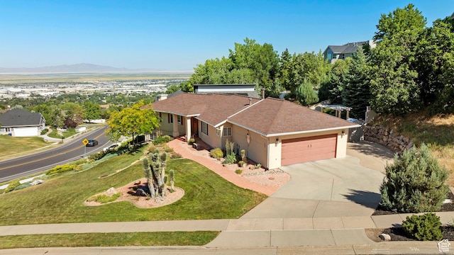 967 E Eaglewood Dr, North Salt Lake, UT 84054 - view of front of house with an attached garage, concrete driveway, stucco siding, a front lawn, and roof with shingles