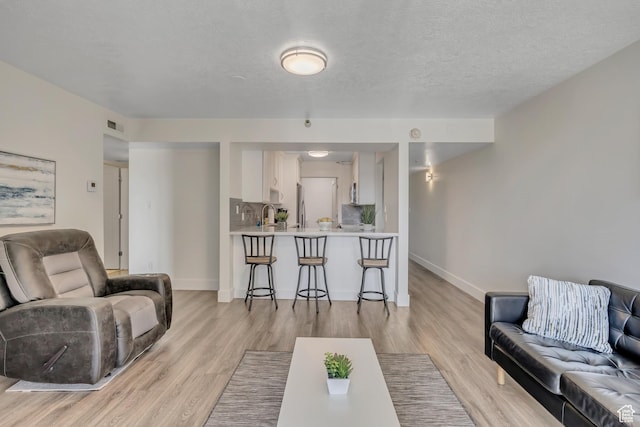 230 E Broadway Unit 401, Salt Lake City, UT 84111 - living area featuring light wood-type flooring and a textured ceiling