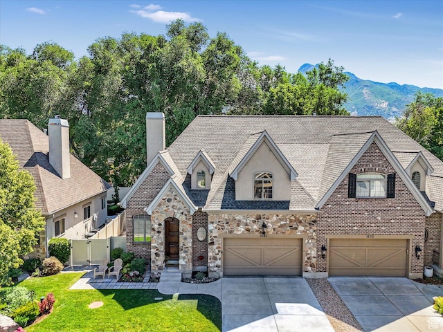 1832 E Cottonwood Glen Ct, Salt Lake City, UT 84117 - french country home featuring an attached garage, concrete driveway, stone siding, and a mountain view