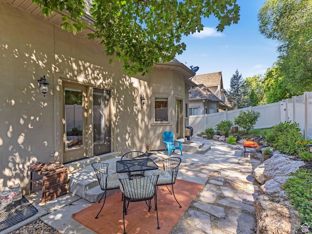 1832 E Cottonwood Glen Ct, Salt Lake City, UT 84117 - fenced backyard featuring a patio and outdoor dining area