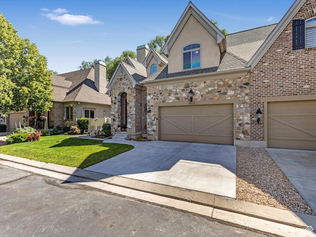 1832 E Cottonwood Glen Ct, Salt Lake City, UT 84117 - french country home featuring a front yard, concrete driveway, stone siding, and a garage