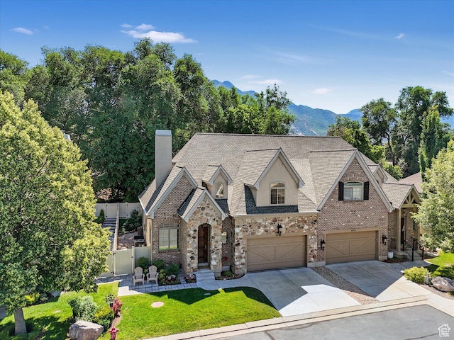 1832 E Cottonwood Glen Ct, Salt Lake City, UT 84117 - view of front of property with a garage, concrete driveway, a chimney, stone siding, and a mountain view