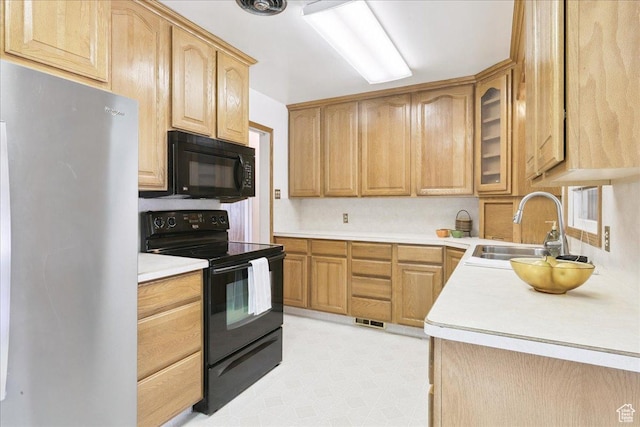 3622 Jackson Ave, Ogden, UT 84403 - kitchen with black appliances, glass insert cabinets, light countertops, and light brown cabinets