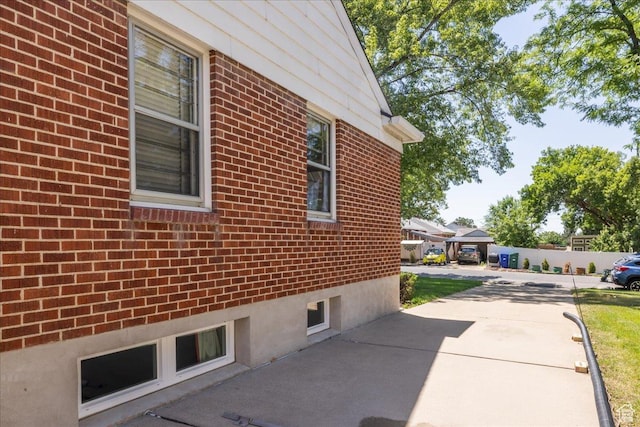 3622 Jackson Ave, Ogden, UT 84403 - view of side of home featuring brick siding and a patio area
