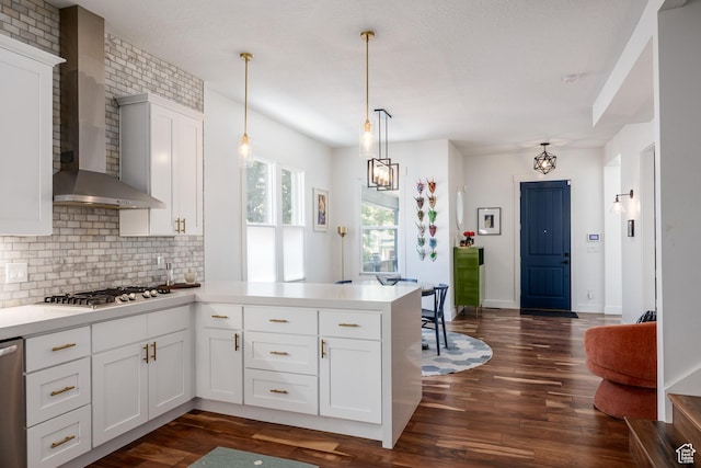 334 N C St, Salt Lake City, UT 84103 - kitchen with wall chimney exhaust hood, a peninsula, decorative backsplash, stainless steel gas cooktop, and dark wood-style floors