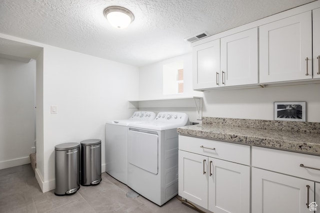 334 N C St, Salt Lake City, UT 84103 - laundry area with washer and dryer, cabinet space, a textured ceiling, and light tile patterned floors
