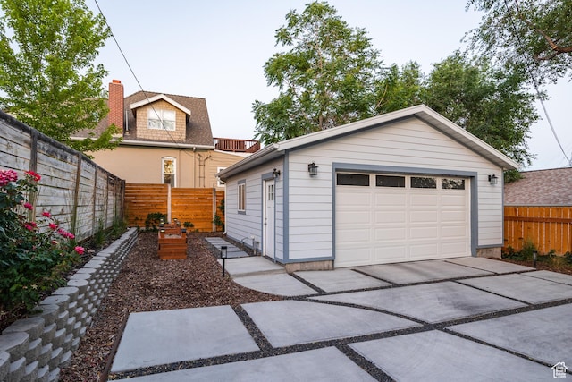 334 N C St, Salt Lake City, UT 84103 - view of front of property featuring a garage, an outbuilding, a fenced backyard, and driveway
