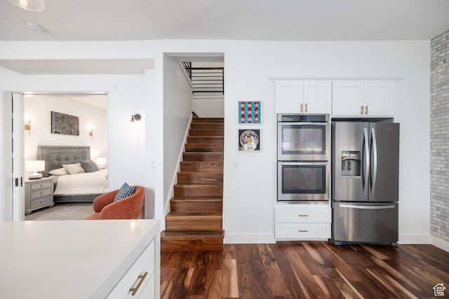 334 N C St, Salt Lake City, UT 84103 - kitchen with appliances with stainless steel finishes, dark wood finished floors, white cabinetry, and light countertops