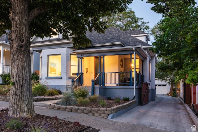 334 N C St, Salt Lake City, UT 84103 - view of front of house featuring an outbuilding, a porch, brick siding, and a garage