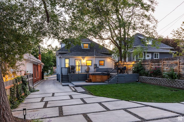 334 N C St, Salt Lake City, UT 84103 - rear view of house with a hot tub, a wooden deck, and an outbuilding