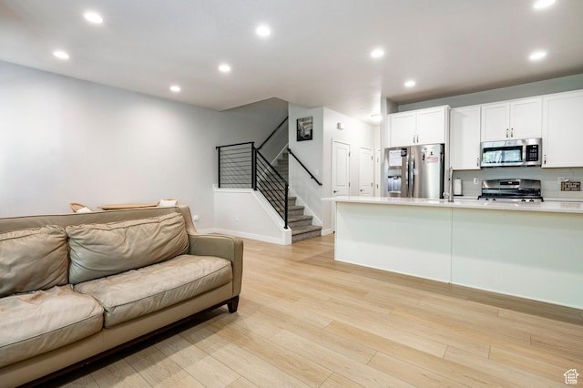 3230 W 3855 S, West Haven, UT 84401 - living room featuring stairway, recessed lighting, and light wood-style floors