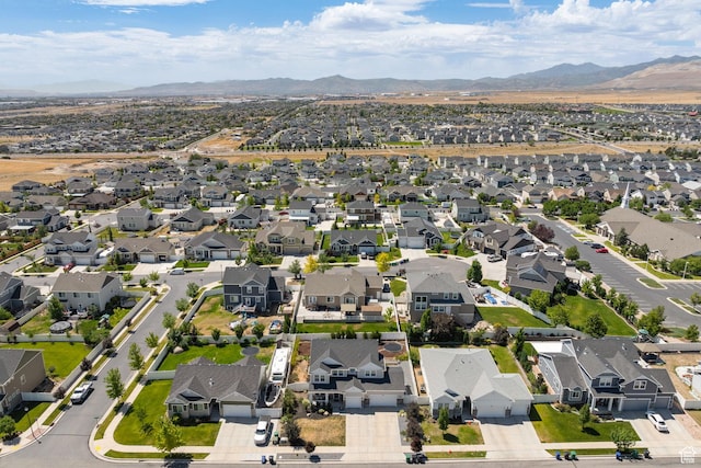 6523 W Bridge Maple Ln S, West Jordan, UT 84081 - aerial view of property and surrounding area with a mountainous background and nearby suburban area