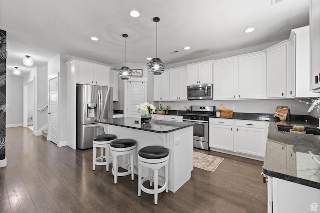 6523 W Bridge Maple Ln S, West Jordan, UT 84081 - kitchen featuring appliances with stainless steel finishes, white cabinets, recessed lighting, a center island, and dark wood-style flooring