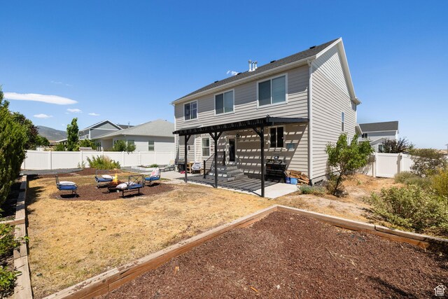 6523 W Bridge Maple Ln S, West Jordan, UT 84081 - back of house with a garden, a patio, a fenced backyard, and a pergola