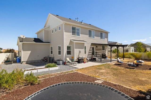 6523 W Bridge Maple Ln S, West Jordan, UT 84081 - back of house featuring a patio area, a fire pit, and a fenced backyard