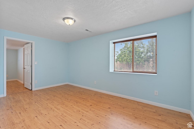 2794 W Harker Ridge Cv, Salt Lake City, UT 84129 - spare room with light wood-type flooring and a textured ceiling