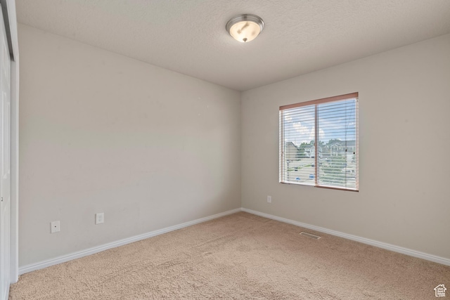 2794 W Harker Ridge Cv, Salt Lake City, UT 84129 - carpeted empty room featuring baseboards and a textured ceiling