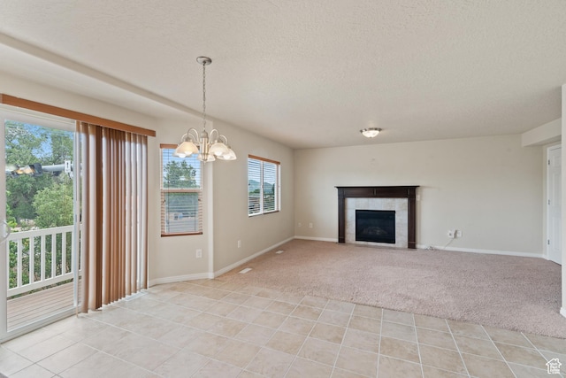 2794 W Harker Ridge Cv, Salt Lake City, UT 84129 - unfurnished living room featuring a textured ceiling, light carpet, a fireplace, a chandelier, and light tile patterned floors