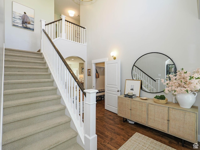 618 E Beaumont Way S, Draper, UT 84020 - staircase with wood finished floors, arched walkways, and a high ceiling