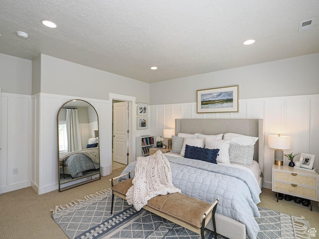 618 E Beaumont Way S, Draper, UT 84020 - bedroom with light carpet, a textured ceiling, recessed lighting, and a decorative wall